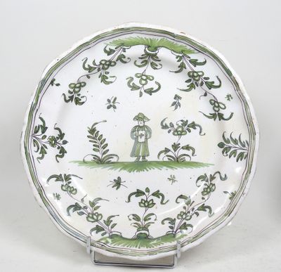 une assiette verte et blanche sur laquelle est représenté un nichoir