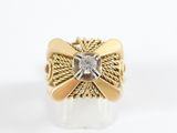 an image of a gold ring with a diamond in the center