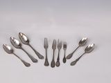 six forks and spoons arranged in a circle on a white surface
