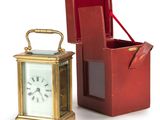 a small red box with a clock inside of it