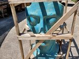 a blue sculpture of a man in a cage