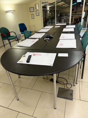 a long table with several papers on it in a room