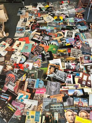 a pile of magazines on the floor next to a teddy bear