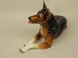 a figurine of a dog laying down on a table