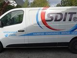 a white van that is parked on the side of the road