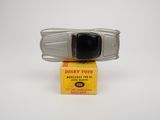 a toy car sitting on top of a box on a white surface