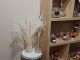 a tall wooden shelf with a vase on top of it