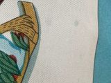 a close up of a shirt with a picture of a bird on it