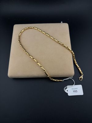 a gold chain with a tag attached to it