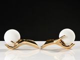 pair of gold and white pearl earrings on a white surface