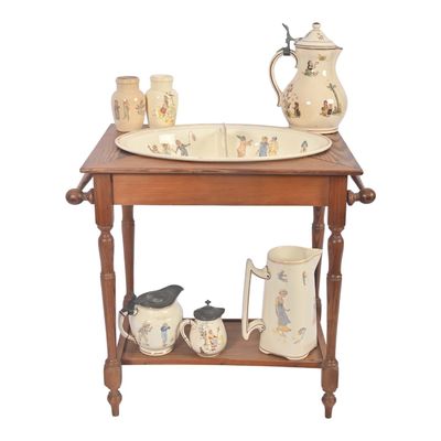 a wooden table with a bowl, pitcher, and cups on it