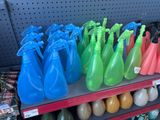 many different colored spray bottles on a shelf in a store