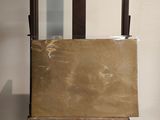 a wooden easel with a piece of paper on top of it