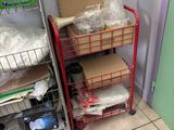 a red cart with boxes on it in a room