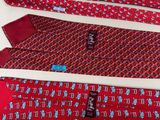 four ties with different designs are laid out on a white surface