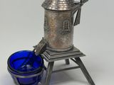 an image of a silver and blue glass candle holder and a blue glass cup