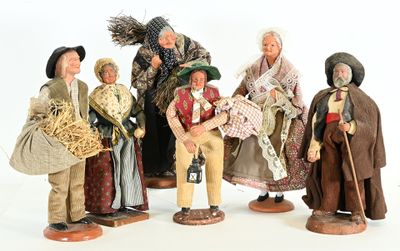 five figurines of people dressed in traditional clothing