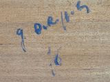 a close up of a piece of wood with writing on it