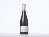 a bottle of wine sitting on top of a white table