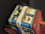 a small toy car with pictures on the side of it