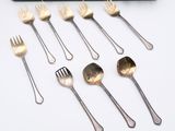 a lot of forks and spoons that are on the table
