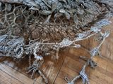 a pile of yarn on the floor with scissors on it
