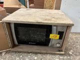 a microwave sitting in a box with a price tag on it