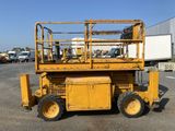 an image of a yellow scissor parked in a parking lot