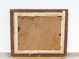 an old picture frame sitting on top of a wooden table