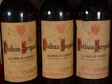 several bottles of red wine are lined up on a table
