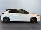 a white car with black rims parked in a room