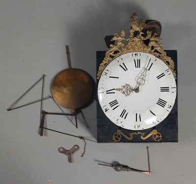 a clock that is sitting on a table next to some tools