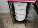 a stack of plates sitting in a dishwasher in a kitchen