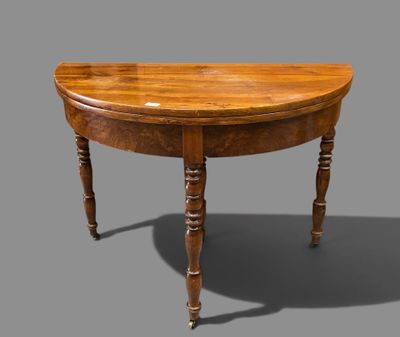 an old wooden table with a curved top and turned legs