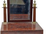 a small wooden vanity with a mirror on it