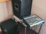 two speakers and a keyboard on a table in a room