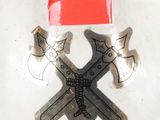 a sticker with two crossed axes and a red hat on it