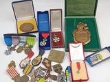 many medals and medals in a case on the table
