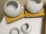 three bowls and two cups sitting on a table