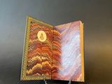 a small book that has a picture of a cat on it