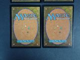 three deck boxes of magic the gathering deck cards on a table