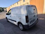 a white van parked in a parking lot next to a building
