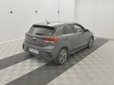 the back end of a grey car parked in a garage