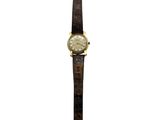 a close up of a watch on a white background