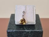 a small box with a ring on it on a table
