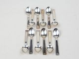 six spoons and two spoon spoons on the table