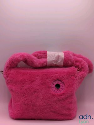 pink teddy bear purse with a white ribbon on top of it