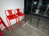three red chairs sitting next to each other in a room