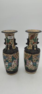 two vases that are sitting on a table
