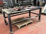 a workbench in a warehouse with a lot of tools on it